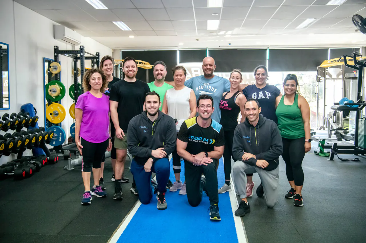 The Studio 84 coaches and members together on the gym floor